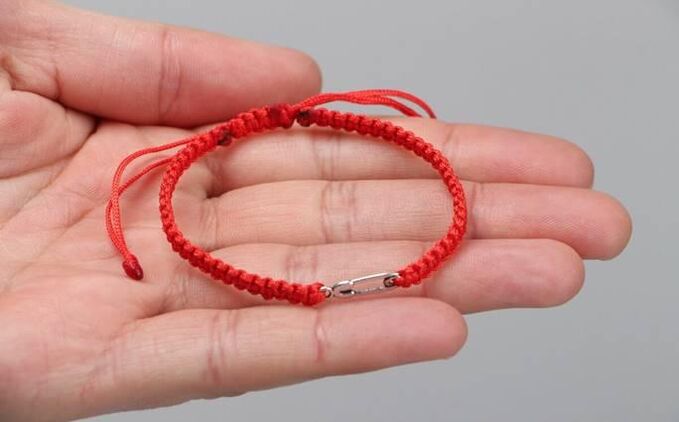 The red thread protects from evil (on the left wrist) and attracts happiness (on the right wrist)